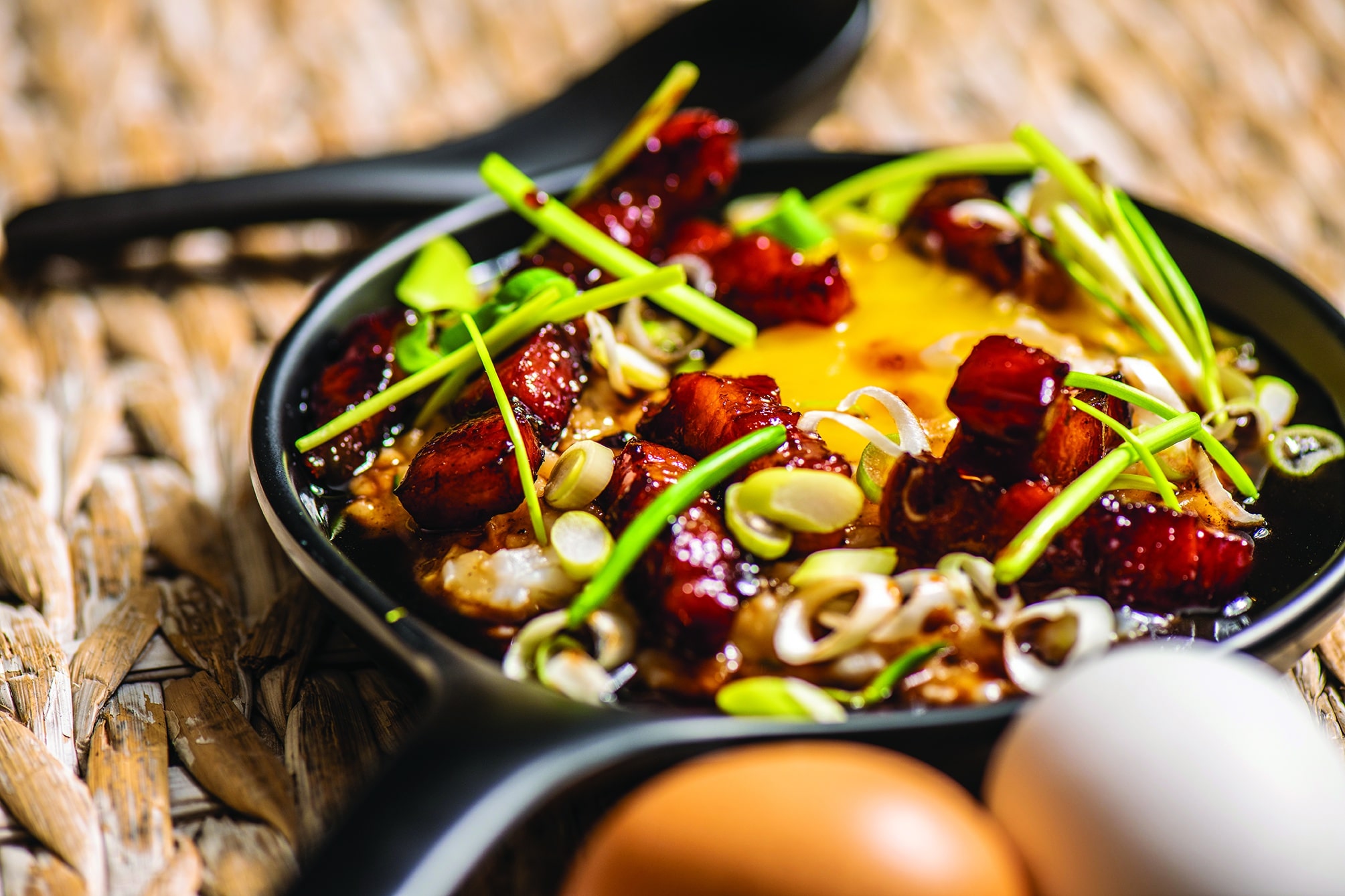 Congee (rice pudding) with soy glazed bacon & egg yolk